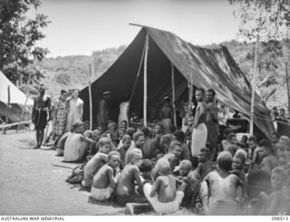 NAMATANAI, NEW IRELAND. 1945-10-29. NATIVES AWAITING TREATMENT AT THE AUSTRALIAN NEW GUINEA ADMINISTRATIVE UNIT NATIVE HOSPITAL WHERE OVER 300 NATIVES ARE BEING TREATED. AN ANGAU ADMINISTRATIVE ..