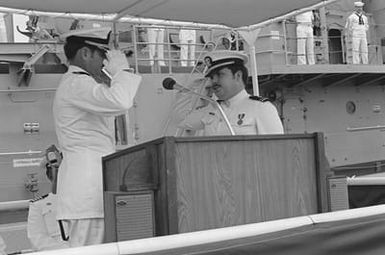 Officers exchange salutes during the decommissioning of the destroyer USS MORTON (DD 948)