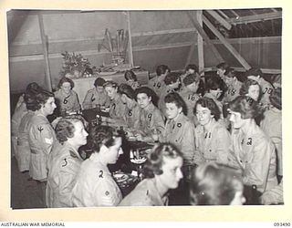 LAE AREA, NEW GUINEA. 1945-07-02. THE SERGEANTS' MESS, AUSTRALIAN WOMEN'S ARMY SERVICE BARRACKS ON THE OCCASION OF THE FIRST FORMAL MESS HELD BY AUSTRALIAN WOMEN'S ARMY SERVICE SERGEANTS IN NEW ..