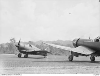 TOROKINA, BOUGAINVILLE ISLAND. C. 1945-01-15. RAAF BOOMERANG AIRCRAFT OF NO. 5 (ARMY CO-OPERATION) SQUADRON RAAF AT PIVA AIRFIELD "WARMING UP" THE ENGINES BEFORE TAKING OFF TO LEAD IN A FLIGHT OF ..