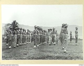 MALMAL MISSION, NEW BRITAIN. 1945-03-12. VX27 MAJOR- GENERAL A.H. RAMSAY, CBE, DSO, ED, GENERAL OFFICER COMMANDING 5TH DIVISION (1), INSPECTING PERSONNEL OF THE 5TH DIVISION PROVOST COMPANY