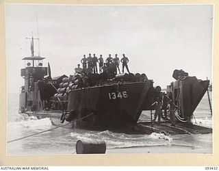 AITAPE BEACH HEAD, NEW GUINEA. 1945-06-19. MEMBERS OF 7 DOCKS OPERATING COMPANY, ROYAL AUSTRALIAN ENGINEERS, ON BOARD A LANDING CRAFT TANK DURING A PAUSE IN THE LOADING OF EQUIPMENT FOR THE WEWAK ..