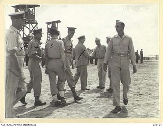 TOROKINA, BOUGAINVILLE ISLAND. 1944-12-15. VX13 LIEUTENANT GENERAL S.G. SAVIGE, CB, CBE, DSO, MC, ED, GENERAL OFFICER COMMANDING, NEW GUINEA FORCE (1) AND PARTY BEING GREETED BY UNITED STATES ARMY ..
