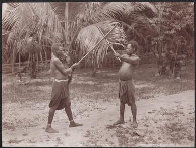 Two men fighting with clubs, Torres Islands, 1906, 1 / J.W. Beattie