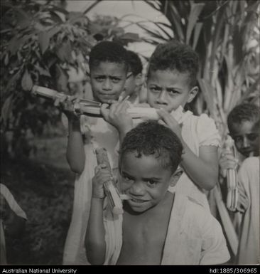 Children eating sugar cane