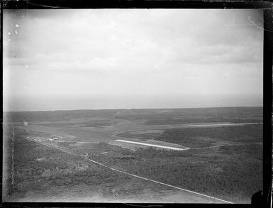 Aerial view of Fua'Amotu Airfield with runways surrounded by bush, Tonga