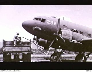 LAE, NEW GUINEA. 1943-10-11. A DOUGLAS TRANSPORT AIRCRAFT, NICKNAMED SANDY, BEING REFUELLED ON THE AIRSTRIP