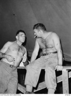 MADANG, NEW GUINEA. 1944-09-16. 36315 SERGEANT EDDIE SCARFE, RAAF (1) AND SX14562 TROOPER JERRY VISSCHER, 2/4TH ARMOURED REGIMENT (2) TWO WELL KNOWN WRESTLERS WHO STAGED AN EXHIBITION BOUT DURING A ..