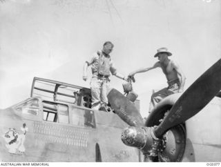 250283 Wing Commander (Wg Cmdr) James Gibson Emerton, the Commanding Officer of No 22 (Boston) Squadron RAAF, climbs from the cockpit of the aircraft, coded DU-K, RAAF serial No. A28-9, on ..