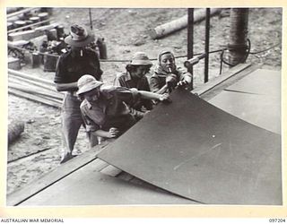 WEWAK POINT, NEW GUINEA. 1945-09-28. MEMBERS OF THE DARYA COLLIN BALLET TROUPE, CURRENTLY TOURING THE SOUTH WEST PACIFIC AREA TO ENTERTAIN TROOPS, ON ARRIVAL AT HEADQUARTERS 6 DIVISION IMMEDIATELY ..