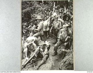 1943-07-08. NEW GUINEA. WAU-MUBO AREA. AN AUSTRALIAN PATROL MOVES ALONG THE MUBO TRACK IN A FORWARD AREA. (NEGATIVE BY G. SHORT)