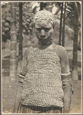 Widows, Ambasi, North Coast [woman covered in clay, wearing a beaded top] Frank Hurley