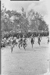 Government-sponsored festival in Tabibuga: adolescent girls run race, watched by large crowd including luluais