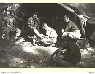 KELANOA, NEW GUINEA, 1944-02-21. PATIENTS AND STAFF AT THE REGIMENTAL AID POST, 5TH AUSTRALIAN DIVISION HEADQUARTERS. IDENTIFIED PERSONNEL ARE: SX16545 LANCE-CORPORAL E.G. SMITH (1); Q100403 ..