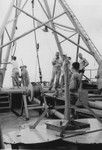 John Isaacs (center) with crew works with oceanographic instrumentation off the stern of R/V Spencer F. Baird, Bikini Atoll area