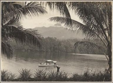 Mt. Victory from Naniau Isld., Cape Nelson, [boat on river with Mt. Victory in background] Frank Hurley