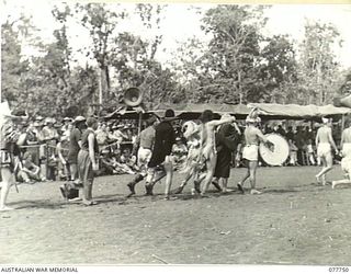 MALAHANG BEACH, LAE, NEW GUINEA. 1944-12-31. THE "TANKS A MILLION CONCERT PARTY", WINNERS OF THE BURLESQUE MARCH PAST AT THE CHRISTMAS FESTIVITIES ARRANGED BY THE ARMY AMENITIES SERVICE, MOVING ..