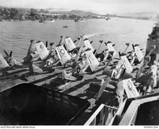 BRISBANE, QLD. C. 1944. SUPERMARINE SEAFIRE II AIRCRAFT, WITH WINGS FOLDED, ON THE DECK OF BRITISH AIRCRAFT CARRIER HMS SLINGER. THE SLINGER IS IN BRISBANE RIVER PREPARING TO LEAVE FOR MANUS ..