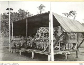 BOUGAINVILLE ISLAND. 1945-01-30. THE OFFICIAL STAND DURING THE INSPECTION OF HEADQUARTERS, 15TH INFANTRY BRIGADE BY THE GENERAL OFFICER COMMANDING, 2ND AUSTRALIAN CORPS. AMONG THE VISITORS CAN BE ..