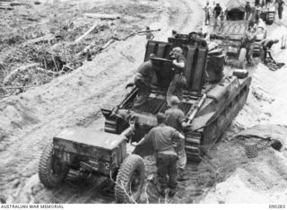 BOUGAINVILLE. 1945-03-30. TANK CREWS OF B SQUADRON, 2/4 ARMOURED REGIMENT, LIFTING ENGINE FLAPS TO WATERPROOF THE ENGINES BEFORE CROSSING THE PURIATA RIVER TO SUPPORT 25 INFANTRY BATTALION. THIS IS ..