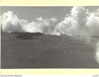 1943-09-15. ALLIED PARACHUTISTS. DROPPING IN THE MARKHAM VALLEY FROM 12 OF THE SCORES OF GIANT TRANSPORT PLANES. IN THE BACKGROUND IS THE SMOKESCREEN LAID IN FIGHTER PLANES TO PROTECT THE ..