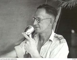 PALMALMAL PLANTATION, NEW BRITAIN. 1945-01-22. B5/29 REPRESENTATIVE K. WATTS, YOUNG MEN'S CHRISTIAN ASSOCIATION SPEAKING TO THE TROOPS OVER THE PUBLIC ADDRESS SYSTEM AT THE 5TH BASE SUB AREA