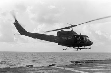 A UH-1 Iroquois helicopter takes off from the flight deck of the amphibious assault ship USS GUAM (LPH 9), during operations off the coast of Beirut, Lebanon