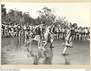 LAE, NEW GUINEA. 1944-08-27. SISTERS FROM THE 2/7TH GENERAL HOSPITAL AND THE 2/8TH GENERAL HOSPITAL ENTERING THE WATER FOR THE START OF THE WOMEN'S 100 YARDS AT THE SURF CARNIVAL ORGANISED BY HQ, ..