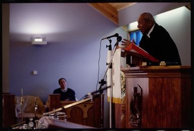 King Taufaʻahau Tupou IV speaks from the pulpit at the dedication of Vaine Moʻonia church