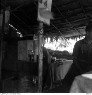 KARAWOP, NEW GUINEA, 1945-09-18. A SIGNALLER OF 2/6 CAVALRY COMMANDO REGIMENT WORKING ON THE SWITCHBOARD