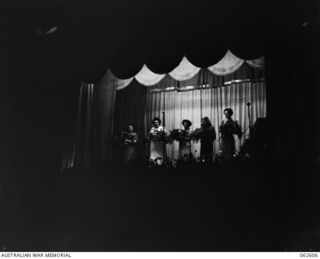 ELA BEACH, NEW GUINEA. 1943-12-21. AT THE CONCLUSION OF THE CONCERT GIVEN FOR THE TROOPS BY MISS GLADYS MONCRIEFF AND HER PARTY OF ENTERTAINERS, THE LADIES WERE PRESENTED WITH BOUQUETS OF FLOWERS ..