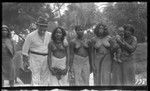 Portrait of several Sikaiana women and infant, with European man