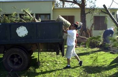 US Air Force (USAF) members from the 36th Maintenance Squadron (MS) pick up trash and debris as a part of a base cleanup on Andersen Air Force Base (AFB), Guam