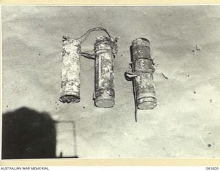 FINSCHHAFEN AREA, NEW GUINEA. 1943-11-24. CAPTURED JAPANESE SMOKE CANDLES ON EXHIBITION AT THE COMMAND ROYAL ENGINEERS, HEADQUARTERS, 9TH AUSTRALIAN DIVISION