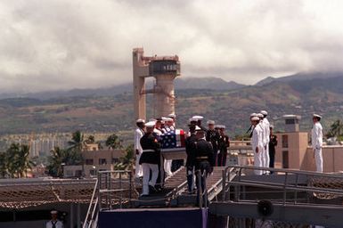 Upon completion of ceremonies, the flag draped casket of the Unknown Soldier of the Vietnam War is carried aboard the frigate USS BREWTON (FF 1086) by a joint service honor guard. The casket will be transported to Alameda, California, and then transferred to its final destination at the Tomb of the Unknown Soldier, Arlington National Cemetery, Virginia