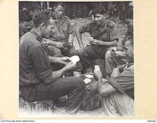 WIRUI BEACH, WEWAK AREA, NEW GUINEA. 1945-09-05. TROOPS OF 2/11 INFANTRY BATTALION PLAYING CARDS. IDENTIFIED PERSONNEL ARE:- PRIVATE J.D. KIDD (1); PRIVATE N. GAYFER (2); PRIVATE T. WAIT (3); ..