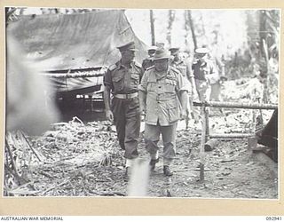 BOUGAINVILLE. 1945-06-08. GENERAL SIR THOMAS A. BLAMEY, COMMANDER-IN-CHIEF, ALLIED LAND FORCES, SOUTH WEST PACIFIC AREA (2), WALKING WITH MAJOR GENERAL W. BRIDGEFORD, GENERAL OFFICER COMMANDING 3 ..