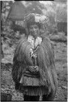 New mother wearing long fiber shawl, fiber skirts, flower garland, skirt valuable on her head, and paint on face