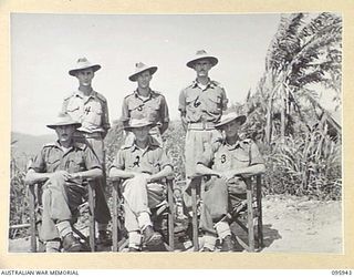 WEWAK POINT, NEW GUINEA. 1945-08-31. LIEUTENANT COLONEL R.R. GORDON, COMMANDING OFFICER 2/3 MACHINE-GUN BATTALION (2), WITH MAJOR L.M. COWAN, SECOND IN COMMAND ( ) AND COMPANY COMMANDERS