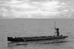 Young woman steering a canoe