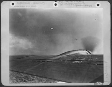 One Of The First Photos Of The Bombing Of Hickam Field, Hawaii, Dec. 7, 1941. Unidentified Planes Over Army Airfield, Hawaii. War Theatre #22 - Hawaii. (U.S. Air Force Number 59997AC)