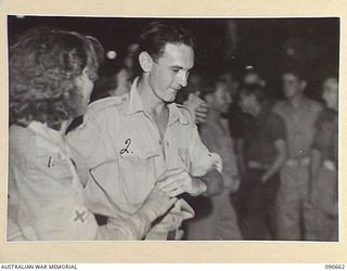 TOROKINA, BOUGAINVILLE. 1945-04-16. AIRCRAFTMAN 1 D.U. DOUGLAS, ROYAL NEW ZEALAND AIR FORCE (2), DANCING WITH PRIVATE I. DIVERALL, AUSTRALIAN ARMY MEDICAL WOMEN'S SERVICE, 2/1 GENERAL HOSPITAL (1), ..