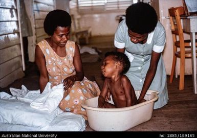 Staff nurse Eunice - bathing baby, Paton Memorial Hospital