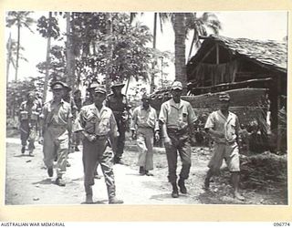 BONIS PENINSULA, BOUGAINVILLE, 1945-09-18. BRIGADIER S.F. LEGGE, OFFICER COMMANDING AUSTRALIAN SURRENDER PARTY FROM HQ 2 CORPS, INSPECTING THE JAPANESE NAVAL HQ, BONIS PENINSULA, ACCOMPANIED BY ..