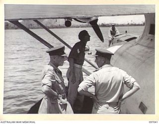 RABAUL, NEW BRITAIN. 1945-09-20. LIEUTENANT GENERAL V.A.H. STURDEE, GENERAL OFFICER COMMANDING FIRST ARMY, IN A SMALL LAUNCH WHICH TOOK HIM FROM THE CATALINA AIRCRAFT TO THE SHORE ON HIS WAY TO ..