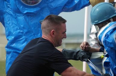 U.S. Air Force SENIOR AIRMAN Christopher Jones and SENIOR AIRMAN David Cantu, both firefighters from the 36th Civil Engineer Squadron, prepare to enter a hazardous materials hot zone during a minor explosion in a warehouse at Andersen Air Force Base, Guam, on Jan. 12, 2005. (USAF PHOTO by TECH. SGT. Cecilio Ricardo) (Released)