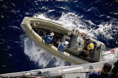 U.S. Navy Arleigh Burke Class Guided Missile Destroyer USS CHUNG-HOON (DDG 93) Sailors use a Rigid Hull Inflatable Boat to ferry Chinese Peoples Liberation Army Navy Sailors back to their ship, the Luhu (Type 052) Class Guided Missile Destroyer QINGDAO (DDG 113), during a Communications and Passing Exercise in the Pacific Ocean on Sept. 10, 2006. (U.S. Navy photo by Mass Communication SPECIALIST 3rd Class Ben A. Gonzales) (Released)