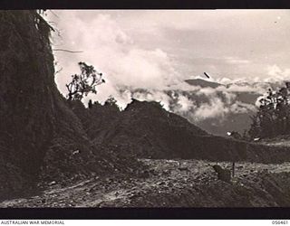 REINHOLD HIGHWAY, NEW GUINEA. 1943-08-24. PORTION OF THE ROAD CONSTRUCTED BY THE TROOPS OF HEADQUARTERS, ROYAL AUSTRALIAN ENGINEERS, 11TH AUSTRALIAN DIVISION BETWEEN JOHNSON'S GAP AND EDIE CREEK, ..