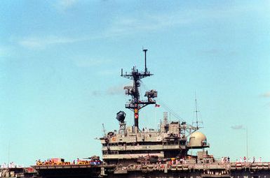 A port side view of the island structure of the amphibious assault ship USS TRIPOLI (LPH-10) as the ship departs from the naval station after a visit. The TRIPOLI is en route to its home port of Naval Station, San Diego, Calif., after serving in the Persian Gulf region during Operation Desert Shield and Operation Desert Storm.