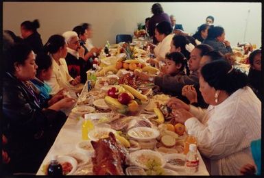 After the Septima devotions, women sit down to eat the banquet cooked and served by the men of the community